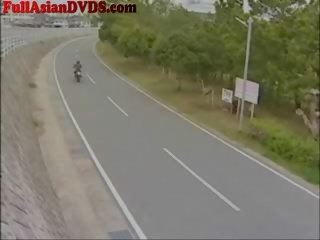 Jap girl Rides toy Motorcylcle